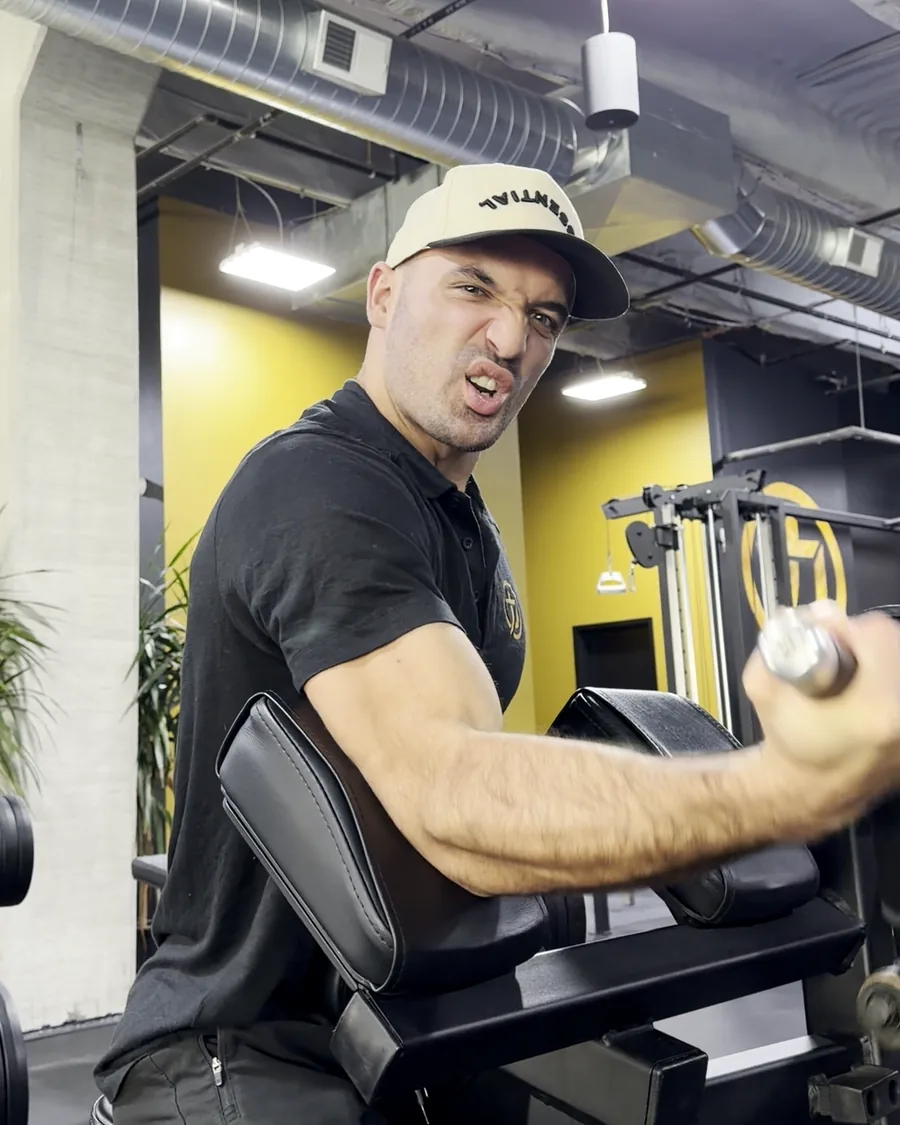 Sam Pitcairn mid-rep on a dumbbell preacher curl